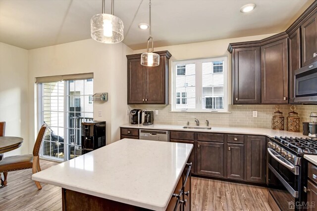 2206 Stelmaszek Rd, Sayreville, NJ 08859 - kitchen featuring appliances with stainless steel finishes, light countertops, dark brown cabinetry, light wood-style flooring, and recessed lighting