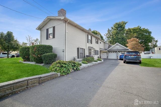 51 Greenbrook Rd, Middlesex, NJ 08846 - view of property exterior with a chimney, a lawn, a garage, and asphalt driveway