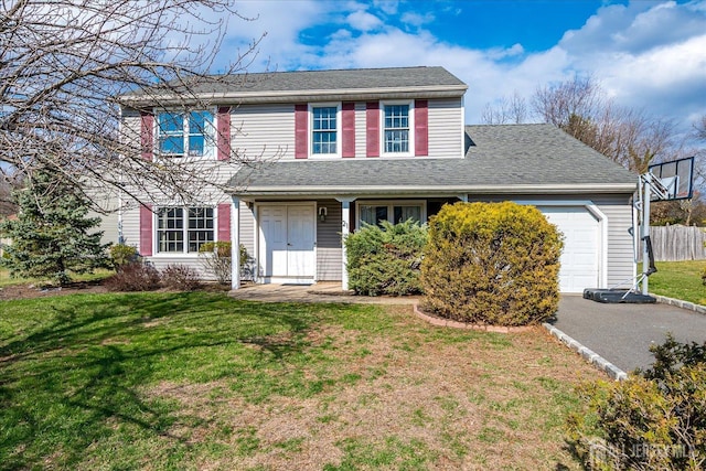 21 Stonewall Dr, Edison, NJ 08820 - view of front of house featuring roof with shingles, fence, an attached garage, and a front yard