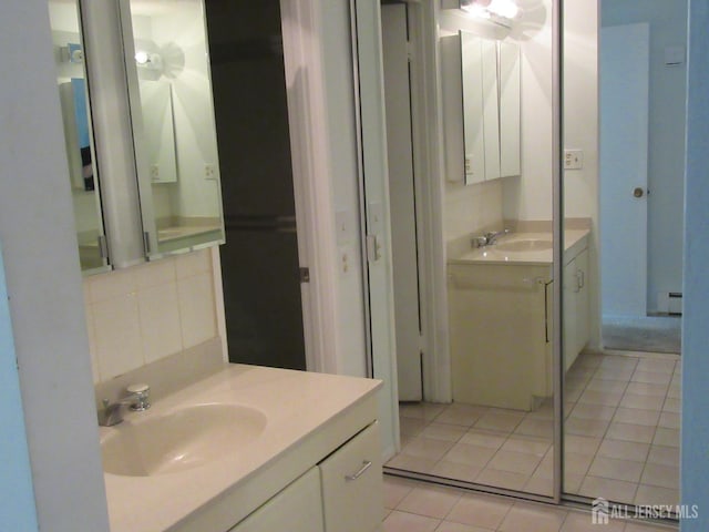 bathroom featuring tile patterned floors and two vanities