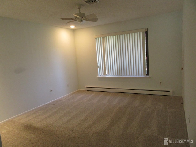 carpeted empty room featuring baseboard heating, ceiling fan, and baseboards