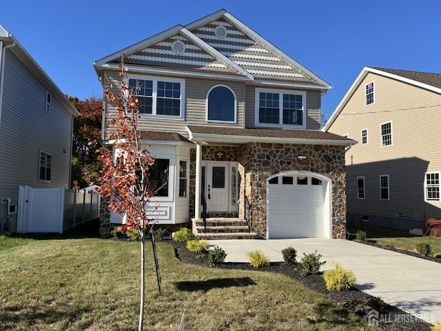 310 Elm St, South Amboy, NJ 08879 - view of front of home featuring driveway, stone siding, a front yard, an attached garage, and fence