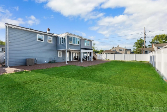 rear view of house with a lawn, a patio area, and central AC unit