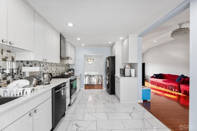 kitchen with stainless steel appliances, white cabinetry, wall chimney exhaust hood, and light hardwood / wood-style floors