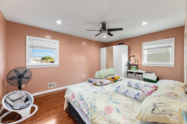 bedroom with ceiling fan and dark wood-type flooring