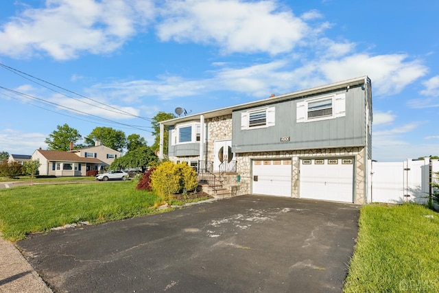 view of front facade with a front yard and a garage