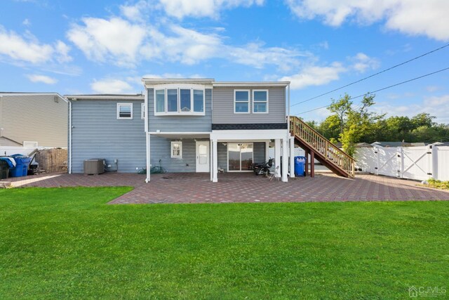 back of property featuring a patio area and a yard