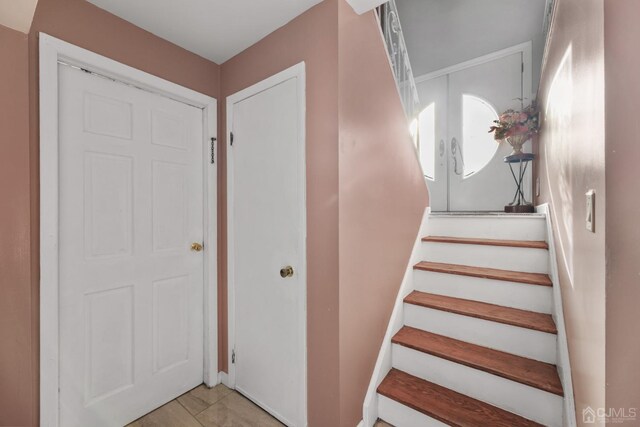 stairs with tile patterned flooring