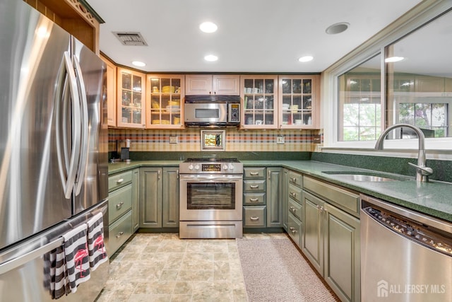 152 Chatham Dr Unit A, Monroe, NJ 08831 - kitchen with stainless steel appliances, green cabinetry, dark countertops, tasteful backsplash, and glass insert cabinets