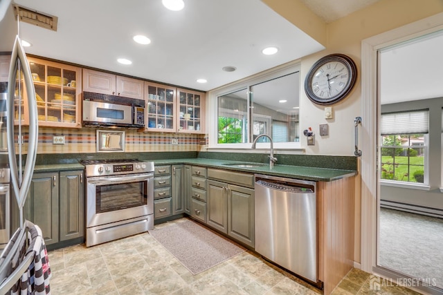 152 Chatham Dr Unit A, Monroe, NJ 08831 - kitchen with stainless steel appliances, a sink, dark countertops, a baseboard radiator, and glass insert cabinets
