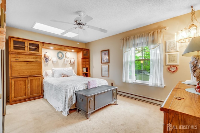 152 Chatham Dr Unit A, Monroe, NJ 08831 - bedroom with a baseboard radiator, light colored carpet, a skylight, a textured ceiling, and ceiling fan