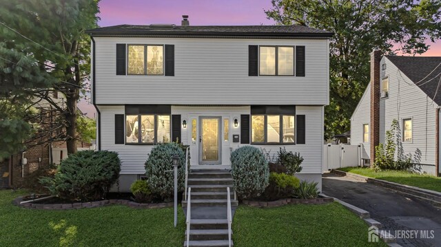 view of front of property with a yard