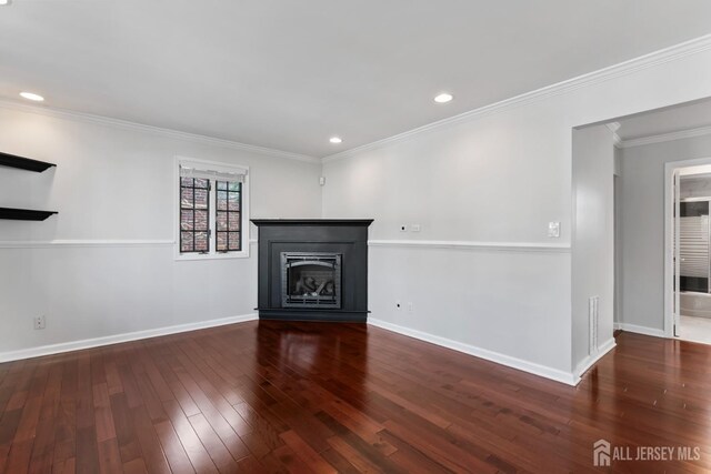 unfurnished living room featuring dark hardwood / wood-style floors and ornamental molding