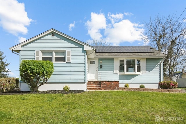 114 Woodrow Ave, Piscataway, NJ 08854 - ranch-style house featuring a front yard, roof mounted solar panels, and entry steps