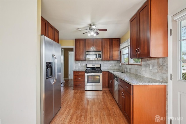 114 Woodrow Ave, Piscataway, NJ 08854 - kitchen with stainless steel appliances, ceiling fan, backsplash, light wood-style flooring, and light stone counters
