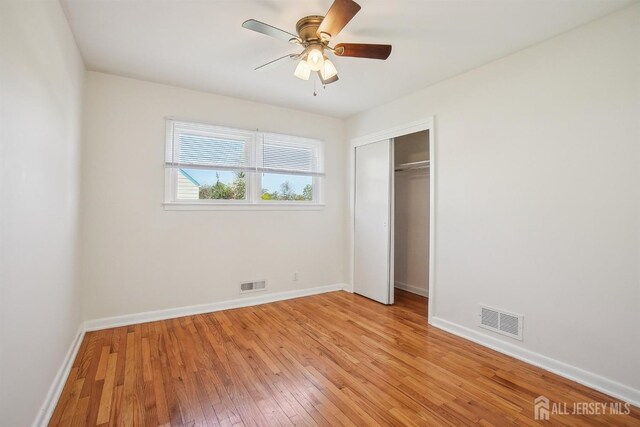 unfurnished bedroom featuring visible vents, light wood finished floors, and baseboards