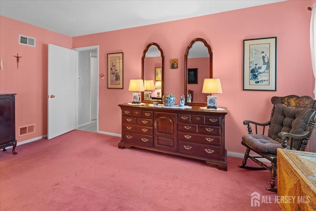 living area with visible vents, carpet floors, and baseboards