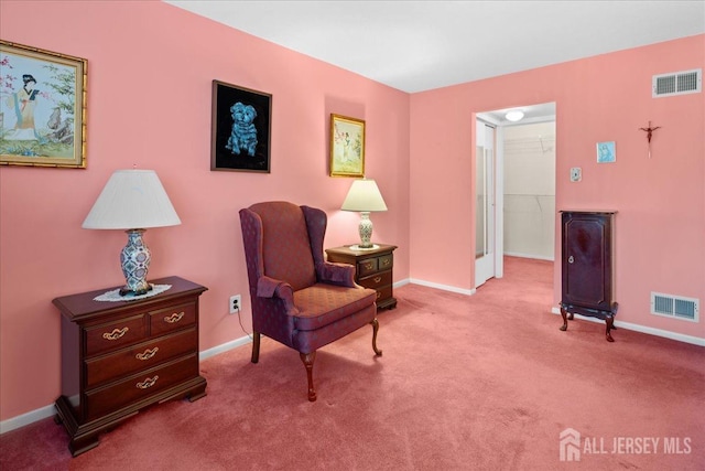 sitting room featuring visible vents, carpet, and baseboards