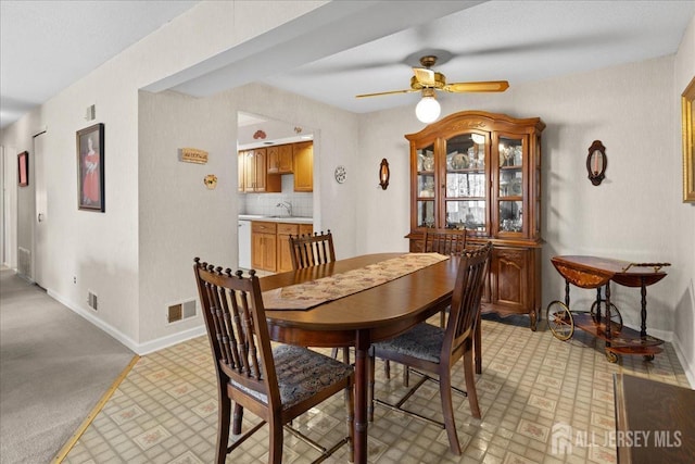 dining area with baseboards, visible vents, and ceiling fan