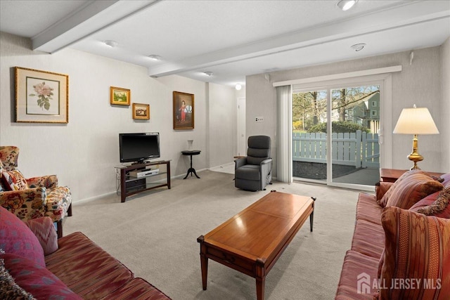 living area with beamed ceiling, light carpet, and baseboards
