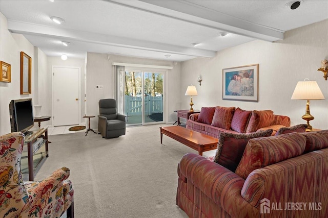 carpeted living area featuring beam ceiling