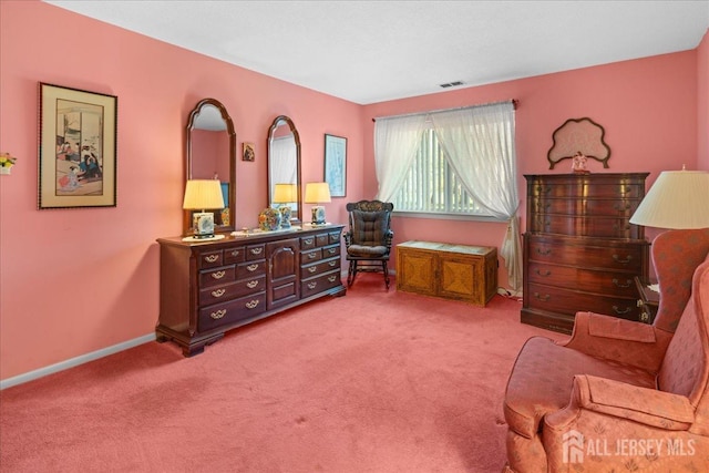 sitting room featuring visible vents, carpet flooring, and baseboards