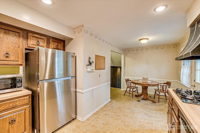 4 Bodnarik Rd, Edison, NJ 08837 - kitchen featuring stainless steel appliances, wall chimney exhaust hood, brown cabinetry, and wooden counters