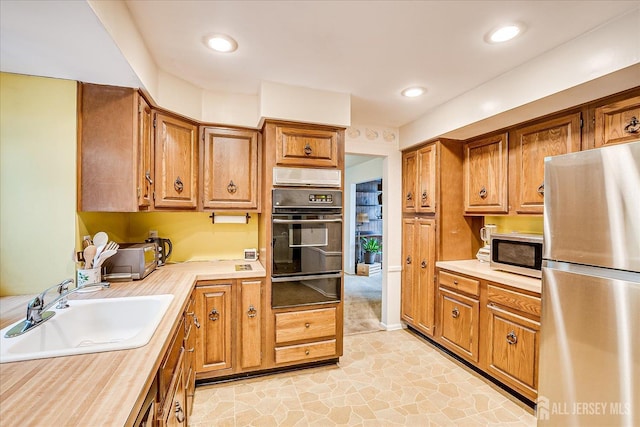4 Bodnarik Rd, Edison, NJ 08837 - kitchen featuring appliances with stainless steel finishes, a warming drawer, light countertops, and brown cabinetry