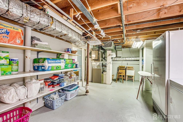 4 Bodnarik Rd, Edison, NJ 08837 - unfinished basement featuring heating unit, freestanding refrigerator, and washer / clothes dryer