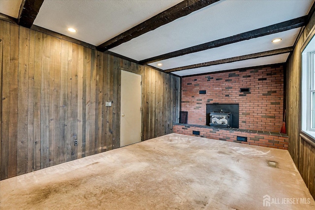 4 Bodnarik Rd, Edison, NJ 08837 - unfurnished living room featuring wood walls, a wood stove, beamed ceiling, and carpet