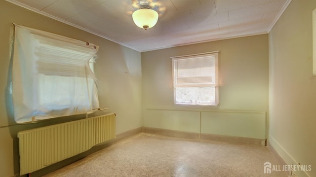 empty room with radiator heating unit and crown molding