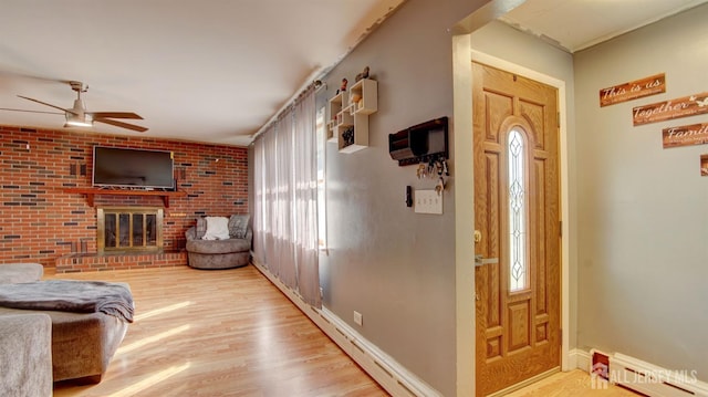 foyer entrance featuring a wealth of natural light, light hardwood / wood-style flooring, and ceiling fan