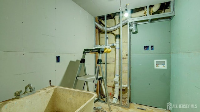 utility room with sink and heating unit