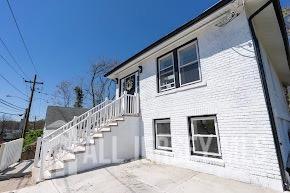 view of side of home featuring a patio and brick siding