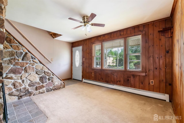 104 Old Matawan Rd, Old Bridge, NJ 08857 - carpeted entryway with a baseboard radiator, wood walls, ceiling fan, and stairway