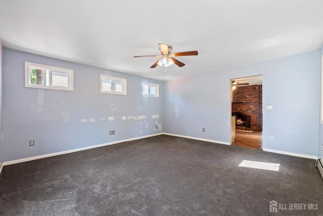 104 Old Matawan Rd, Old Bridge, NJ 08857 - carpeted empty room featuring a ceiling fan, plenty of natural light, and a brick fireplace