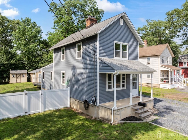 104 Old Matawan Rd, Old Bridge, NJ 08857 - view of home's exterior with covered porch, a shingled roof, a chimney, a shed, and a gate