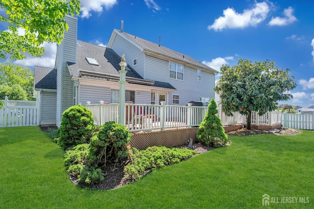 back of property featuring a wooden deck, a chimney, and a shingled roof