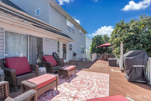 view of patio featuring a wooden deck, area for grilling, and an outdoor living space