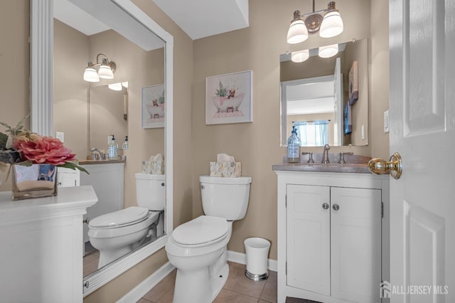 bathroom featuring tile patterned floors, toilet, vanity, and baseboards