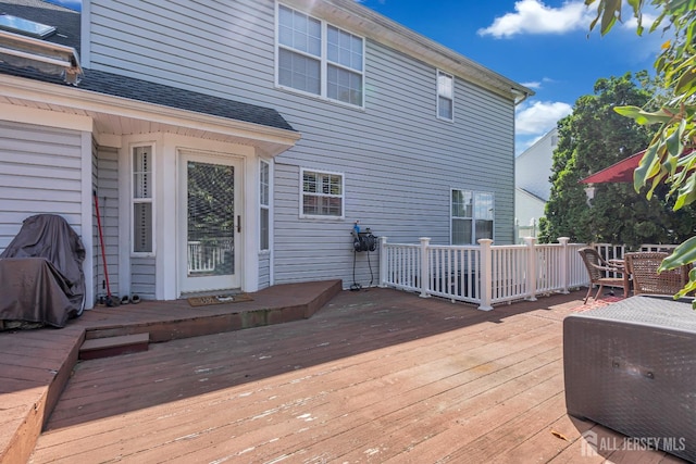 wooden terrace featuring outdoor dining area