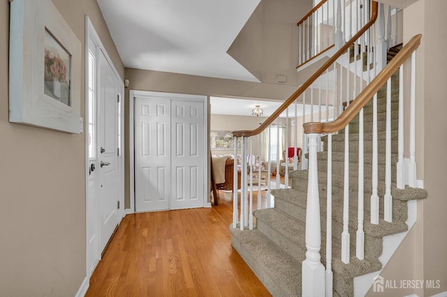 foyer entrance with stairs and wood finished floors