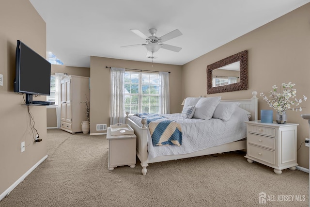 bedroom featuring light carpet, baseboards, and ceiling fan