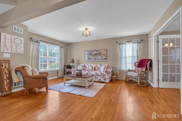 living area with plenty of natural light and light wood finished floors