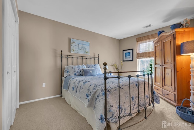 bedroom featuring light colored carpet and baseboards