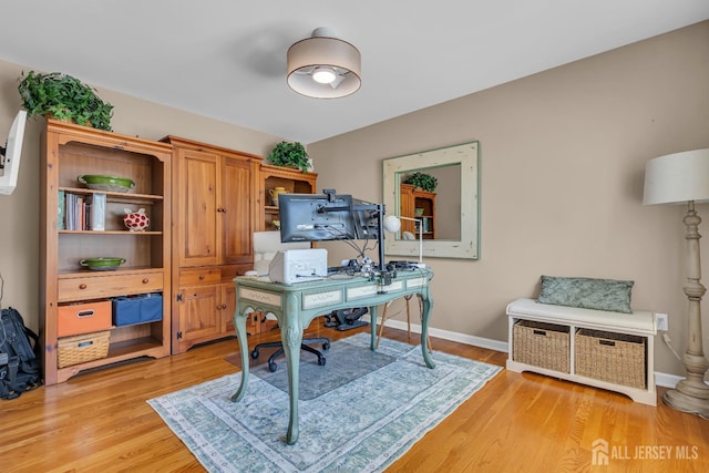 office area with light wood-type flooring and baseboards