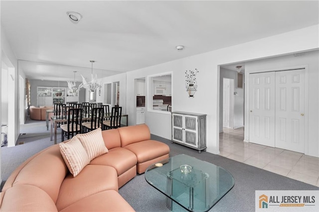 29 Ethan Allen Dr Unit B, Monroe, NJ 08831 - tiled living room with a chandelier and carpet flooring