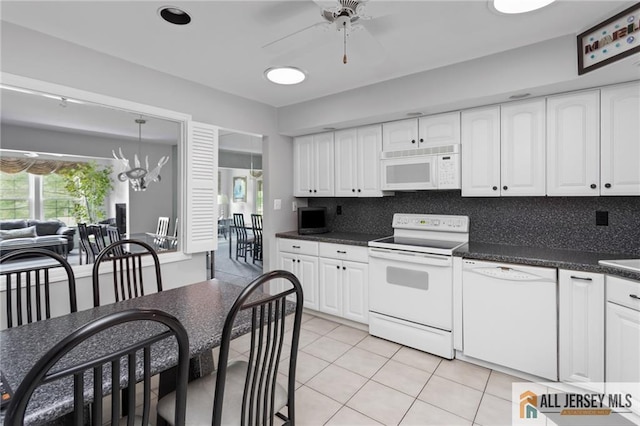 29 Ethan Allen Dr Unit B, Monroe, NJ 08831 - kitchen featuring white appliances, dark countertops, a ceiling fan, light tile patterned floors, and white cabinets