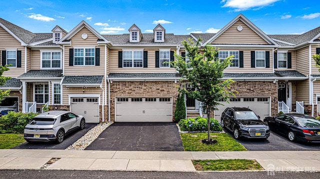 18 Larkspur Ln, Monroe, NJ 08831 - multi unit property featuring driveway, a garage, a shingled roof, and stone siding