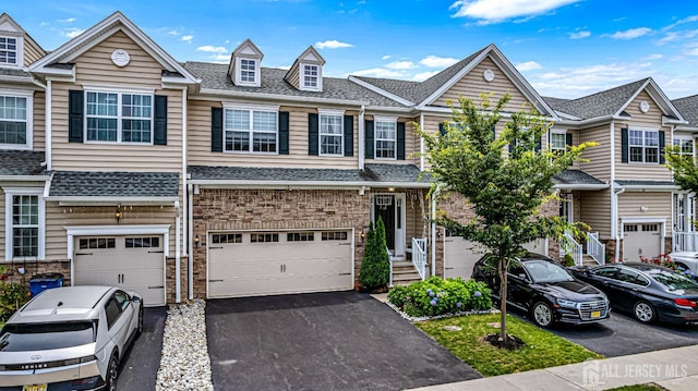 18 Larkspur Ln, Monroe, NJ 08831 - view of property with an attached garage, driveway, and a shingled roof